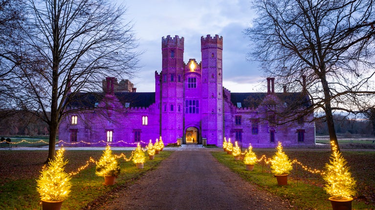 Festive lights illuminating the exterior of the Hall at Oxburgh Estate Norfolk